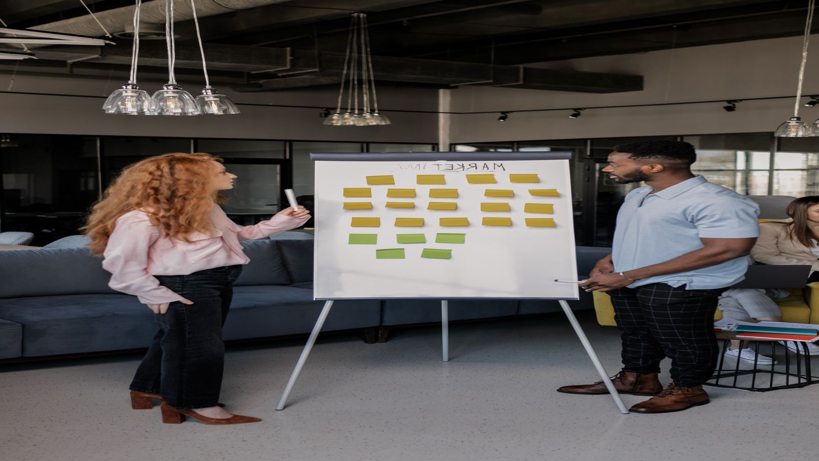 A split image showing code on one side and a meeting room on the other